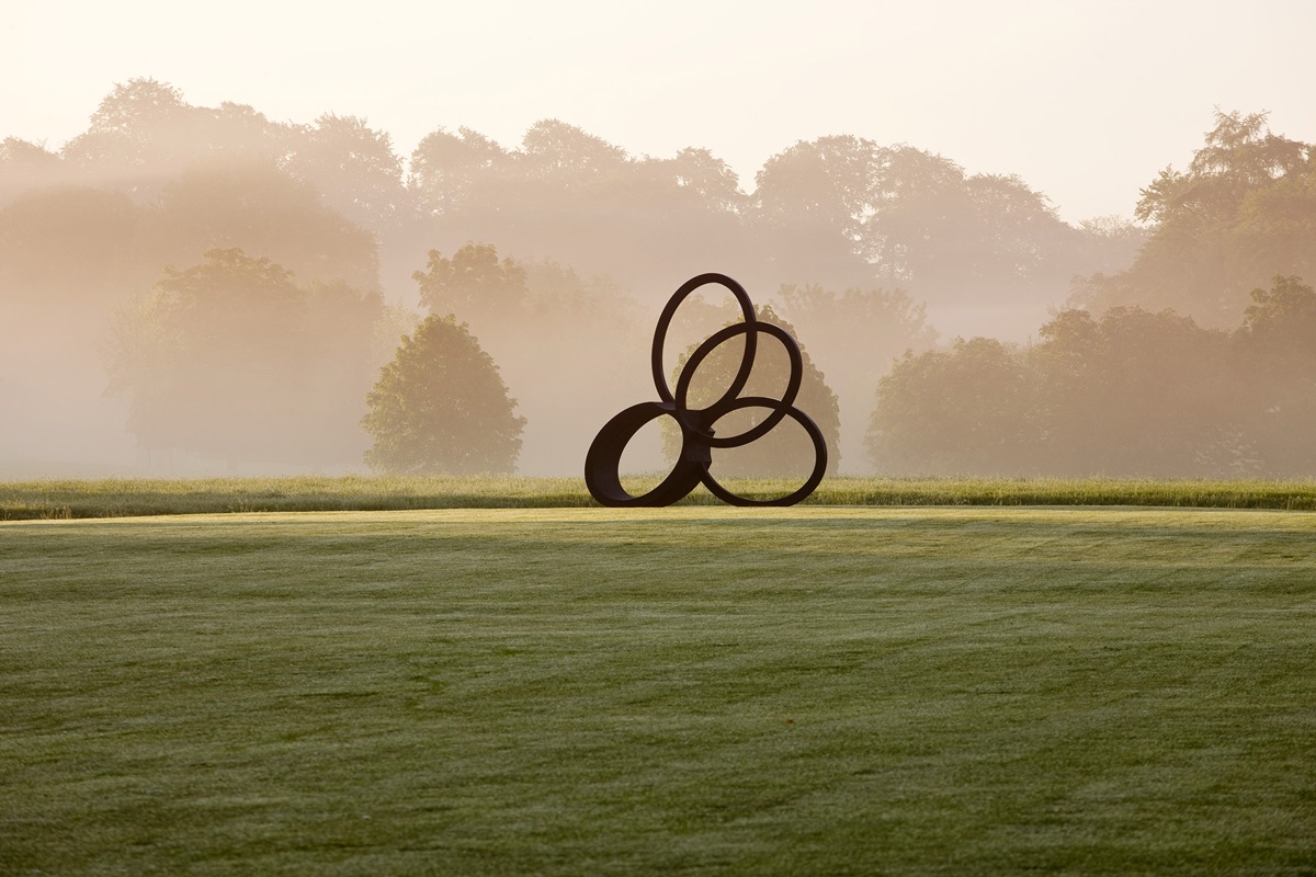 Rockcliffe House, Gloucestershire: View Across Haha To Bronze Sculpture Southern Shade By Nigel Hall. Mist, Fog, Green, Summer