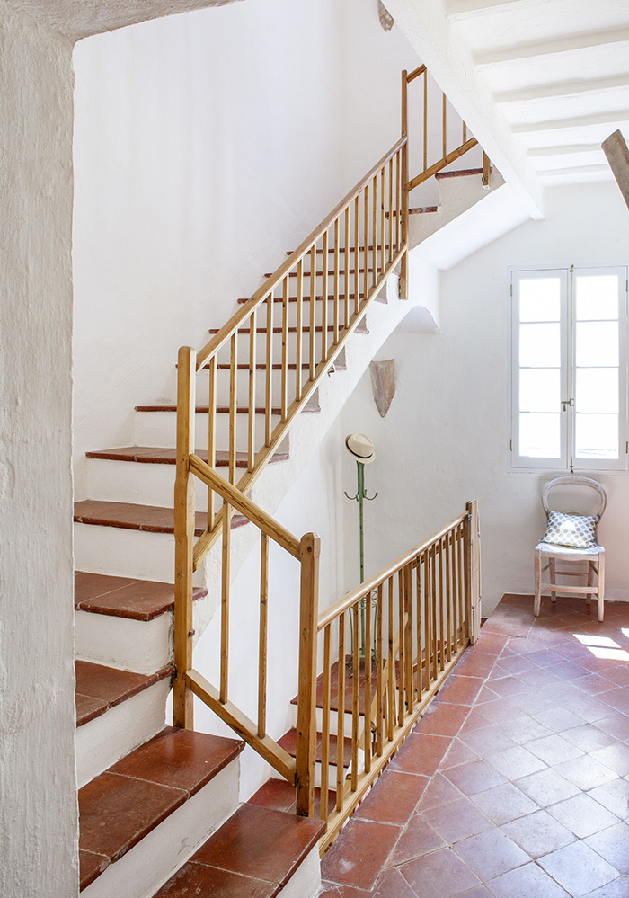 Ciutadella Menorca, Spain: Evelyne Mandel House - Wooden Staircase With White Walls And Terracotta Tiles On Floor - Green Antique Parisian Hat Stand