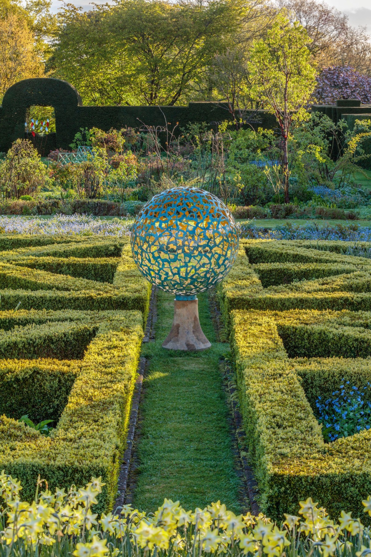 A David Harber sculpture at the end of a parterre