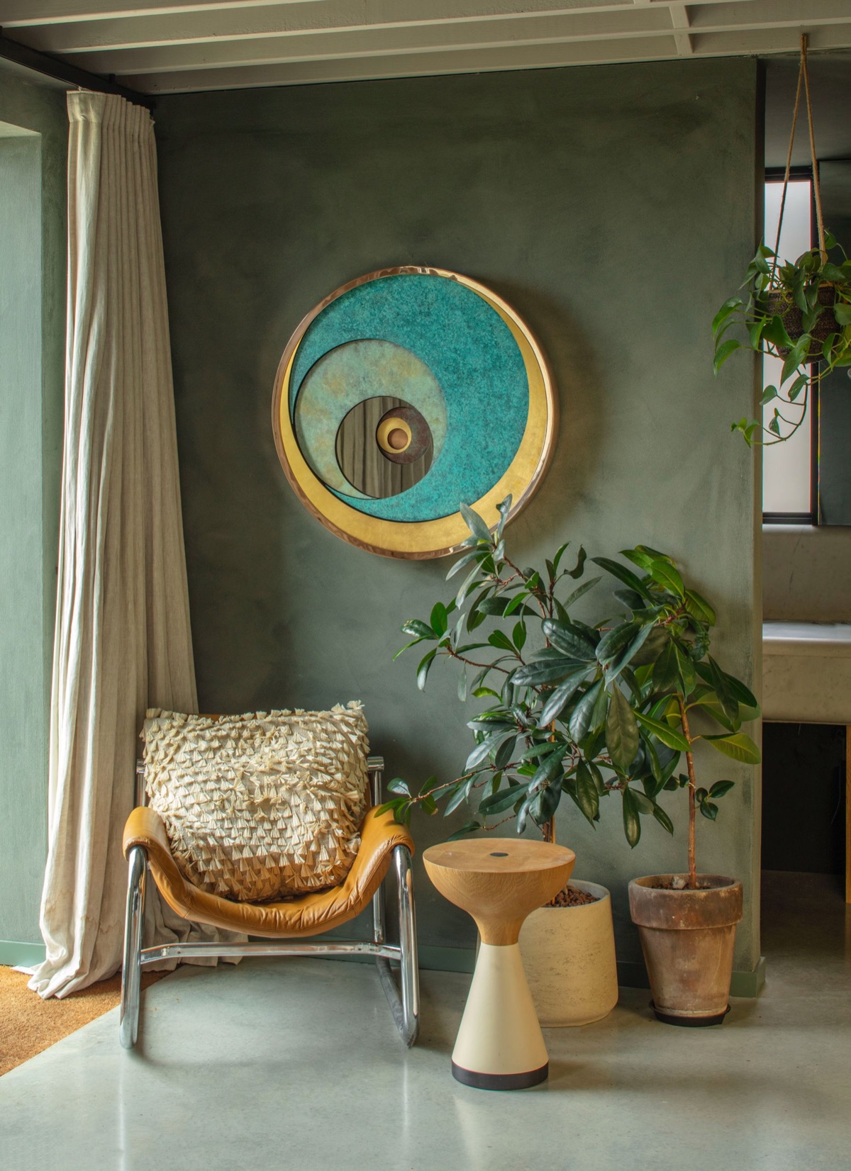 A David Harber wall piece in a green-walled room